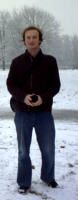 Thmoas Steiner with half-long hair standing in a snowy landscape.